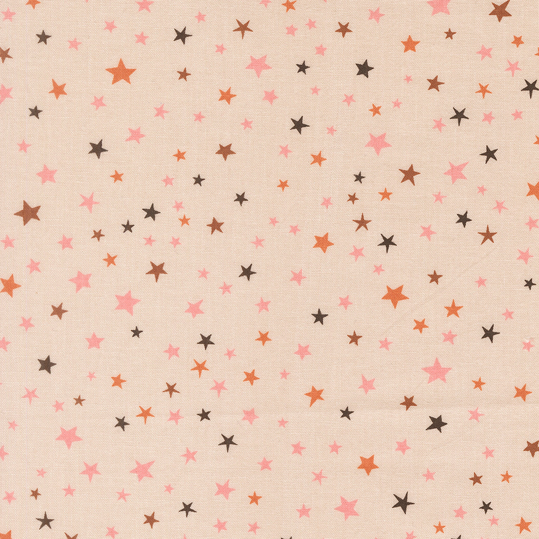 Pattern of small stars in various colors on a beige background