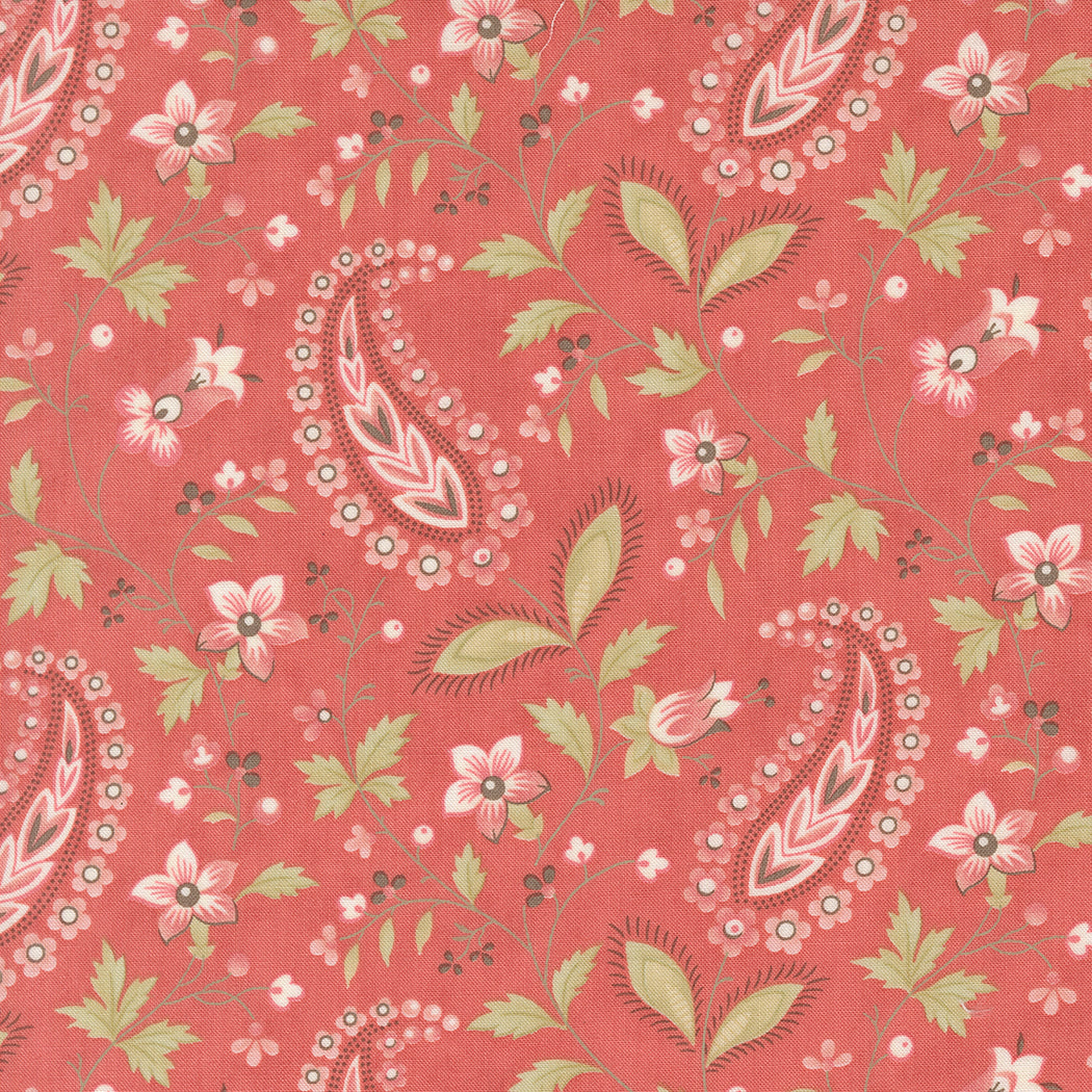 fabric swatch of a paisley print of pink hearts and florals and greenery on a scarlet red background