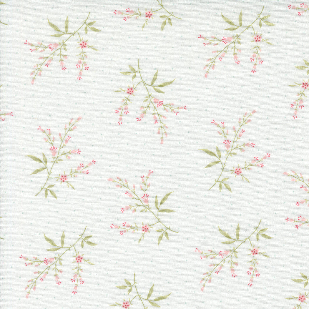 fabric swatch with small pink florals and greenery sprinkled on a porcelain white background with blue dots