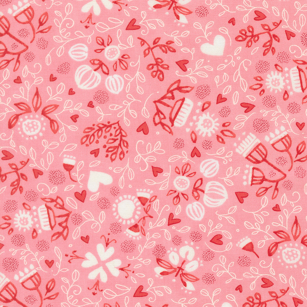 Pink fabric with red and white floral and heart pattern