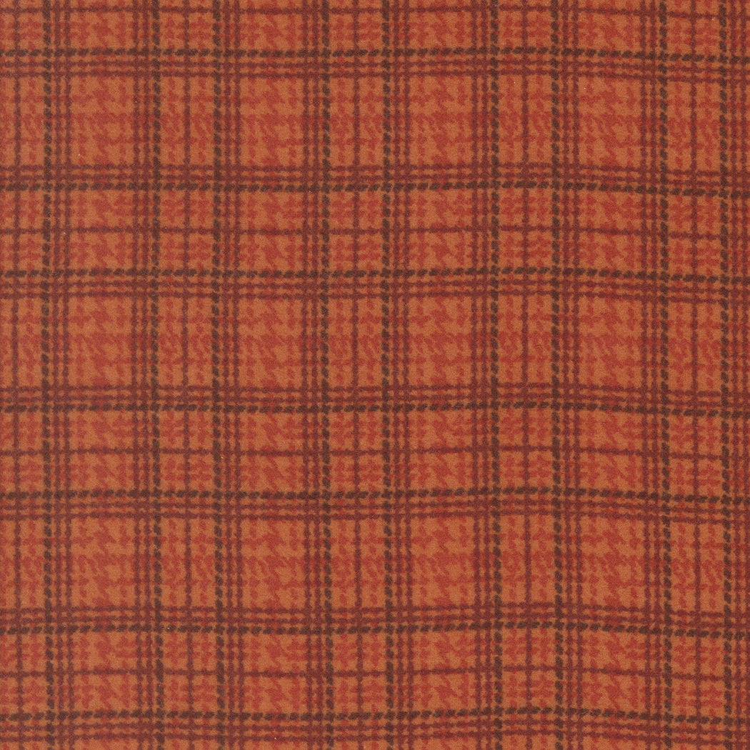 Plaid pattern with brown and black lines on a red-brown background