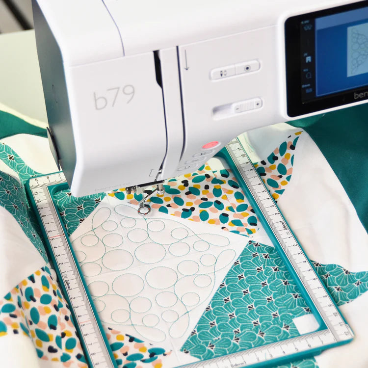 Sewing machine with patterned fabric and ruler on a table