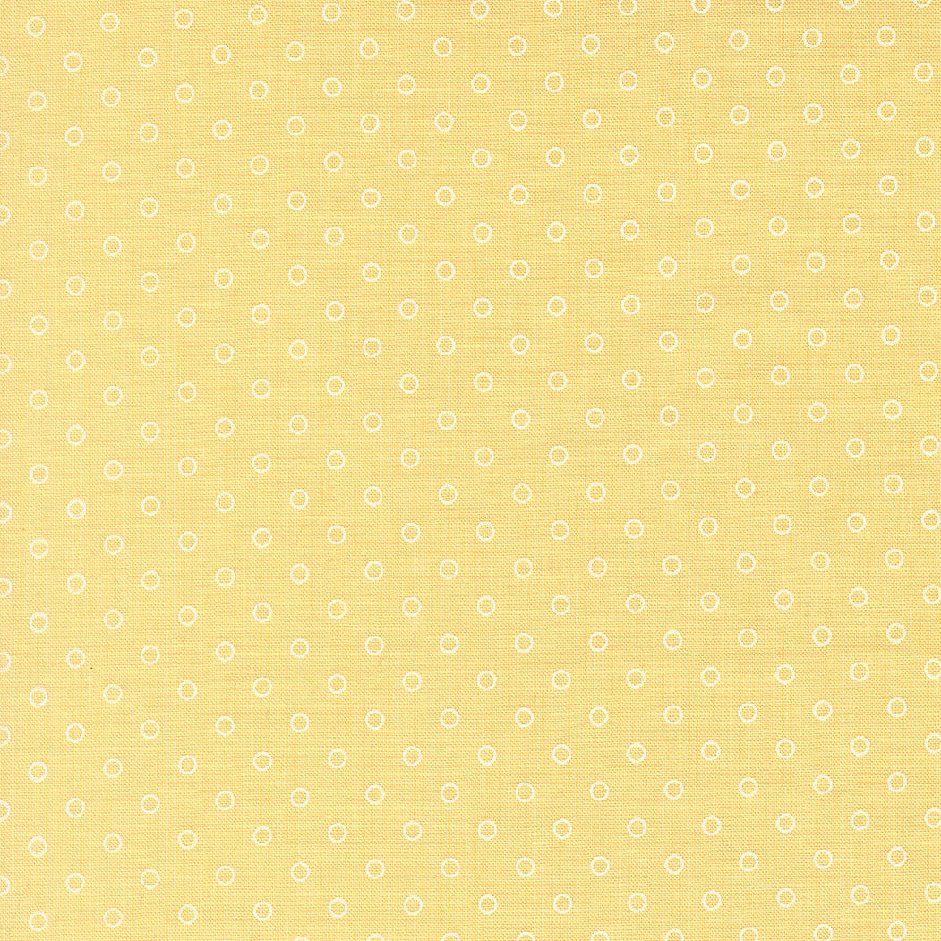 Yellow fabric with small white floral patterns