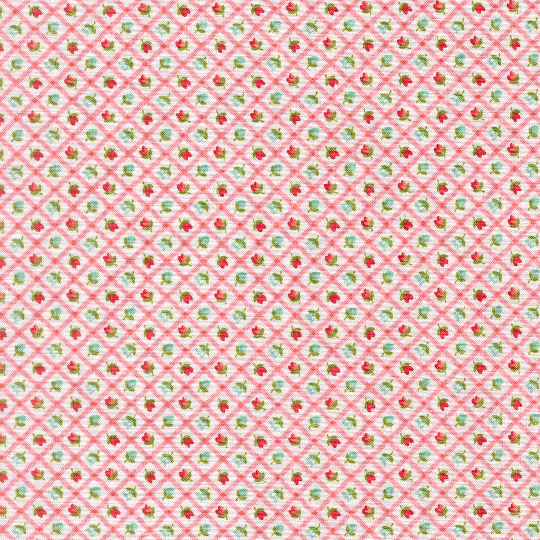 Patterned fabric with small red and green floral design on a pink background