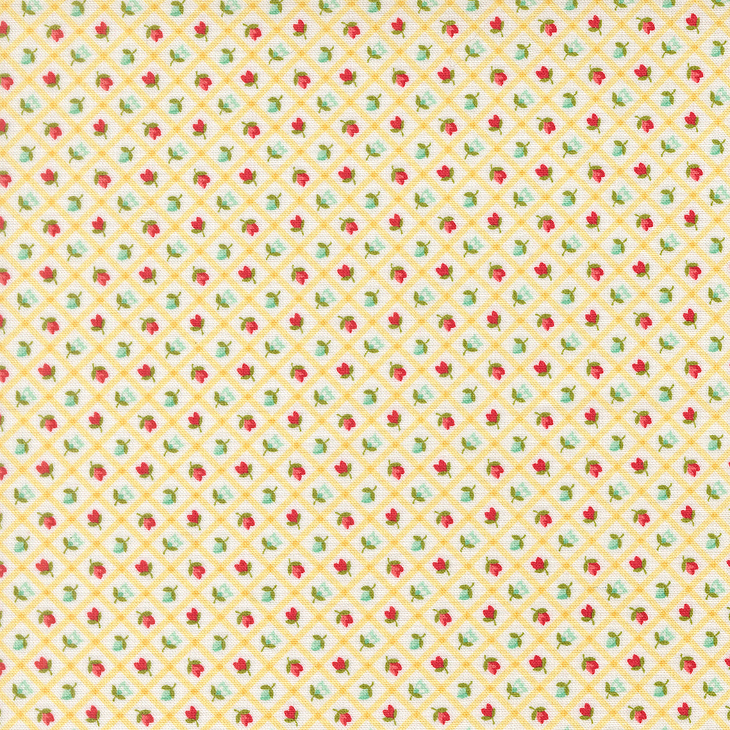 Patterned fabric with small red and green floral design on a yellow background