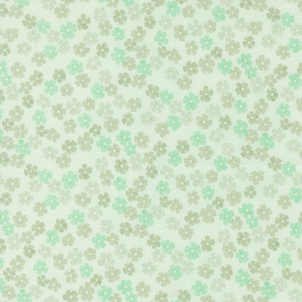 Pattern of small flowers in green and beige on a light background