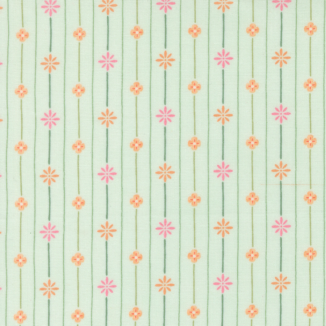 Patterned fabric with small floral designs on a light green background