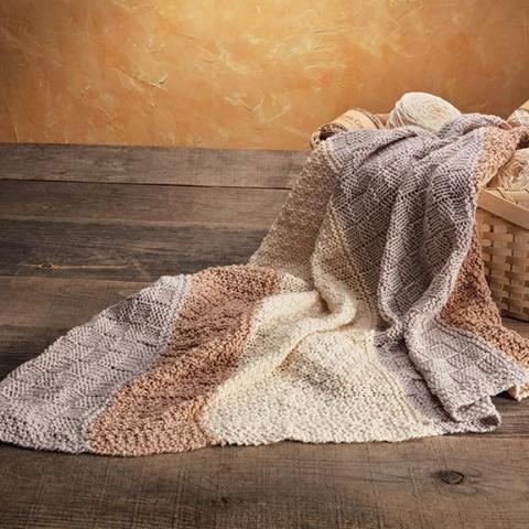Pick A Knit Baby Blanket sample shown draped on a basket