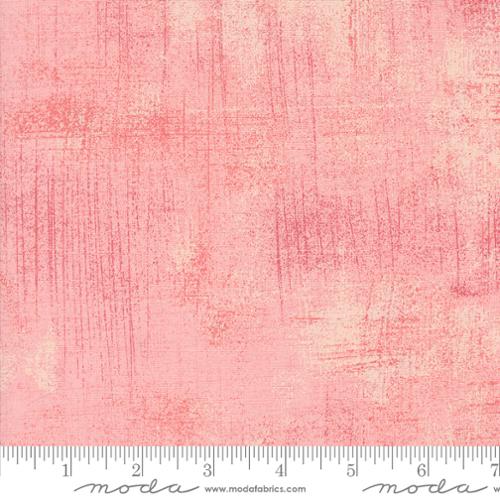 Pink textured fabric with a ruler at the bottom for scale, featuring the Moda Fabrics logo.