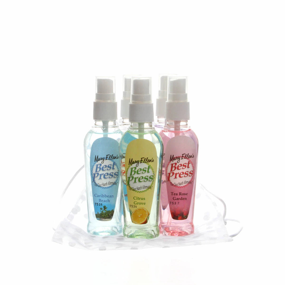 Three small spray bottles with different colored labels on a white background