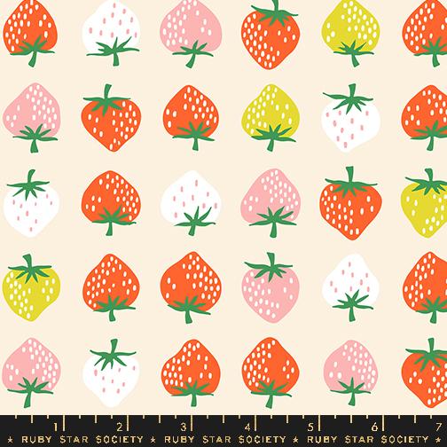 Colorful strawberries on a cream background