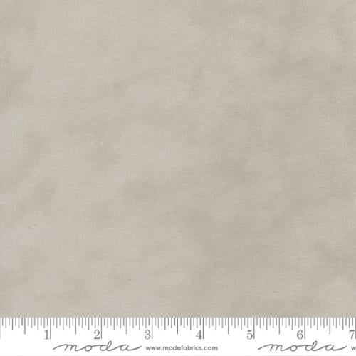 Solid beige fabric swatch with a ruler at the bottom for scale, featuring the Moda Fabrics logo.