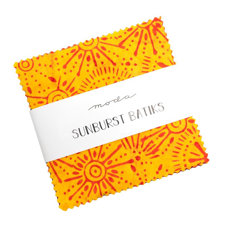 Two yellow fabric swatches with red sunburst patterns on a white background, featuring the 'Moda Sunburst Batiks' label.