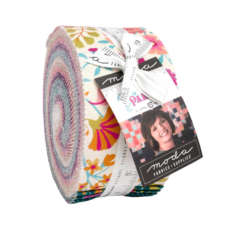 Fabric roll with colorful patterns and Moda label on a white background