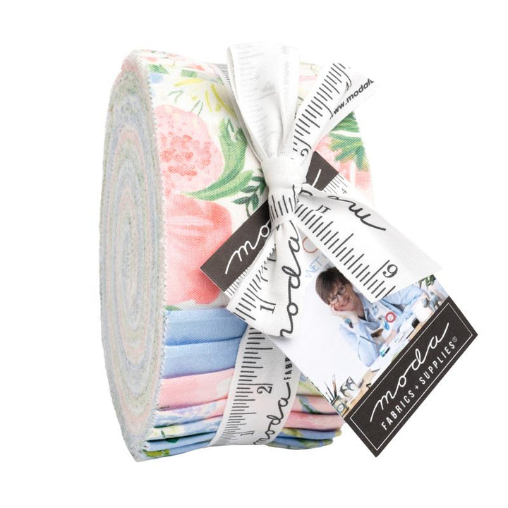 Roll of floral fabric with a ruler and Moda label on a white background