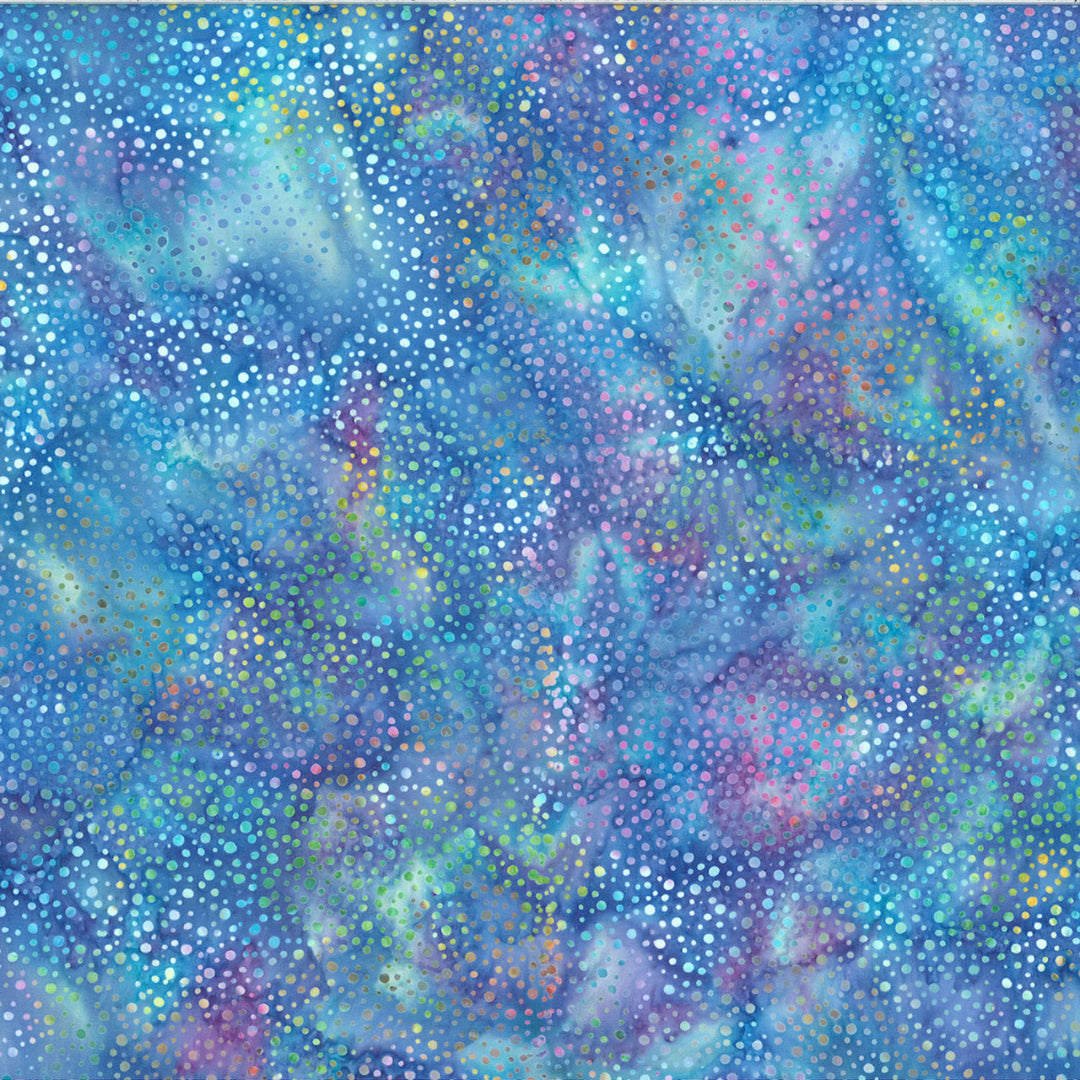 Rainbow Batik fabric with shades of blue in the background and multi colored dots