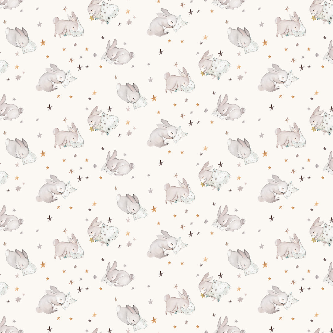 bunnies curled up taking a nap on a cream background and small stars