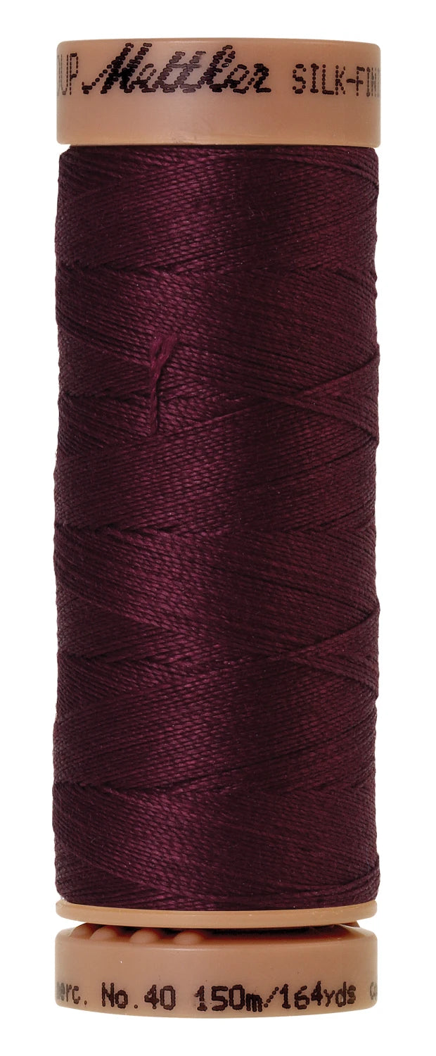 spool of Bordeaux colored thread