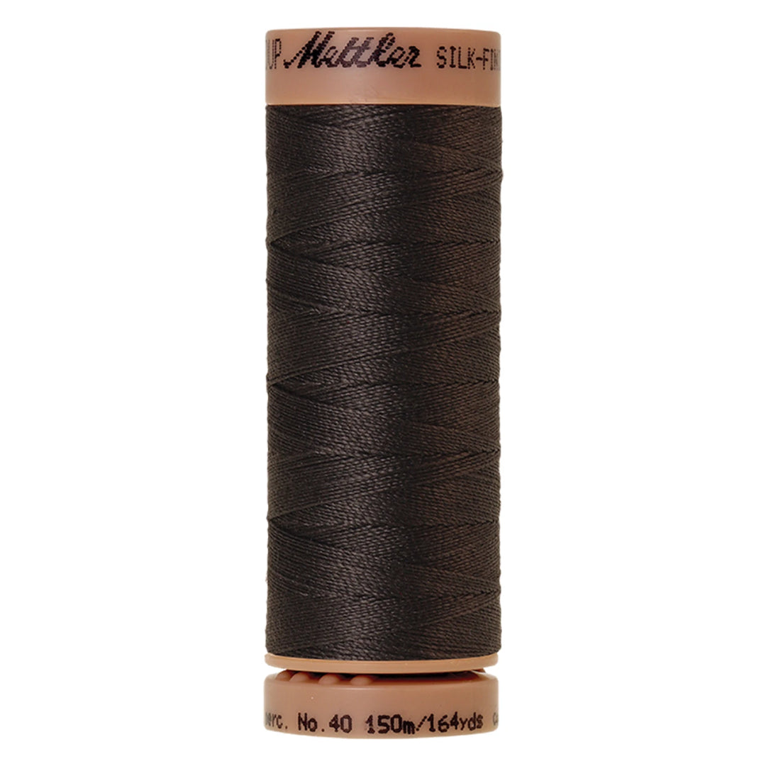 spool of charcoal colored thread