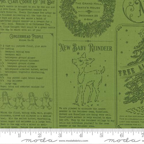 Green fabric with Christmas-themed text and graphics, including gingerbread people and a baby reindeer, with a ruler at the bottom.
