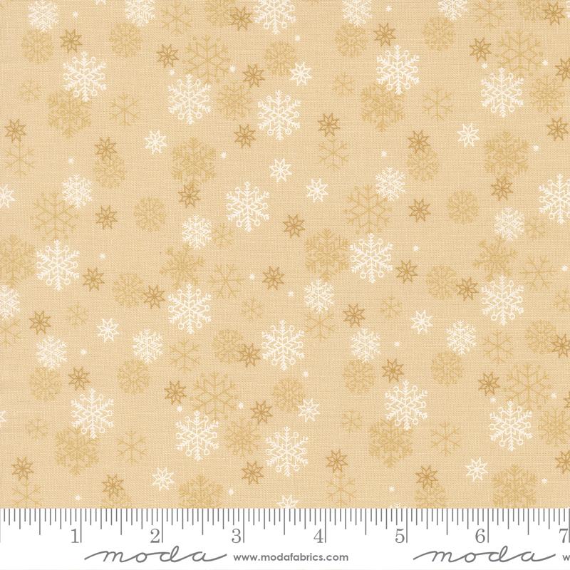 Beige fabric with white and gold snowflake pattern, featuring a ruler at the bottom.
