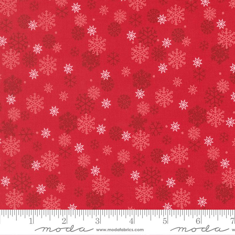 Red fabric with snowflake pattern and Moda label