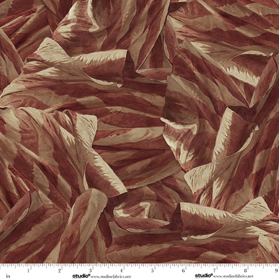 Close-up of textured red and beige fabric with a ruler at the bottom.
