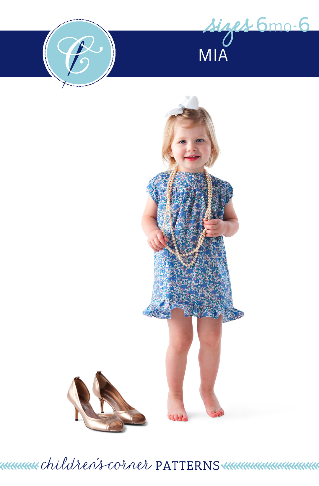 Young girl in a blue floral dress with high heels on a white background