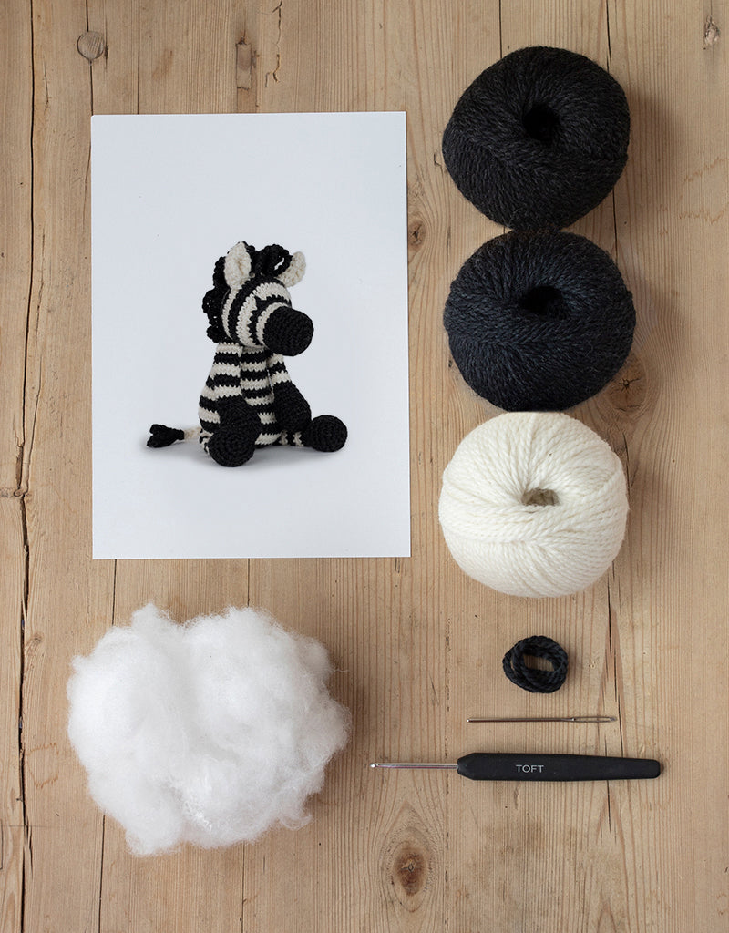 Alice the Zebra kit includes yarn, stuffing, needle, and crochet hook