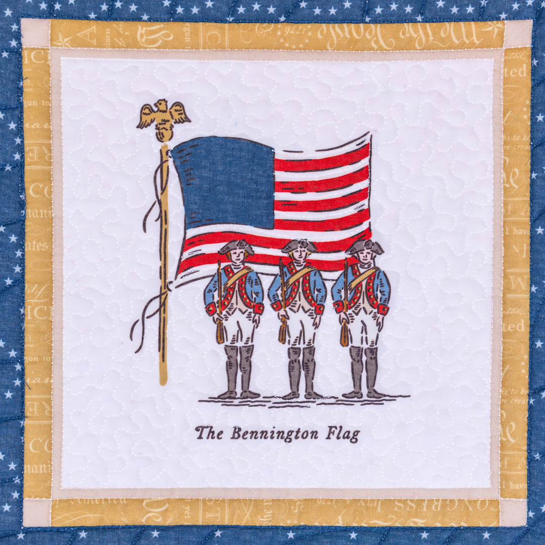Quilt block with illustration of three soldiers holding the Bennington Flag, framed by a decorative border.