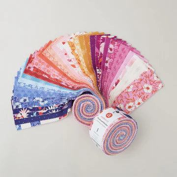 Collection of colorful fabric rolls on a light gray background
