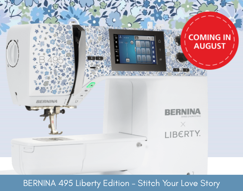 BERNINA 495 Liberty Edition sewing machine with Liberty fabric pattern on a blue floral background.