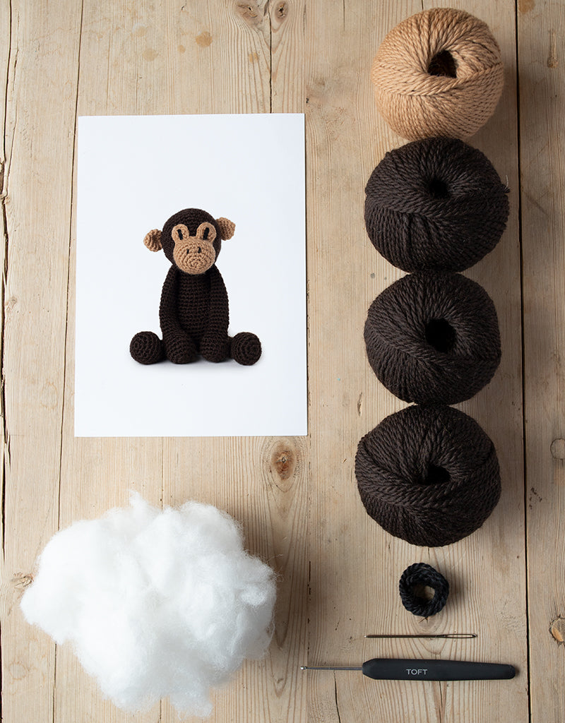 Benedict the Chimpanzee kit includes yarn, stuffing, needle, and crochet hook