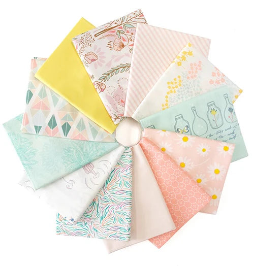 Fat quarter bundle of fabrics in light shades of pinks, blues, and yellow