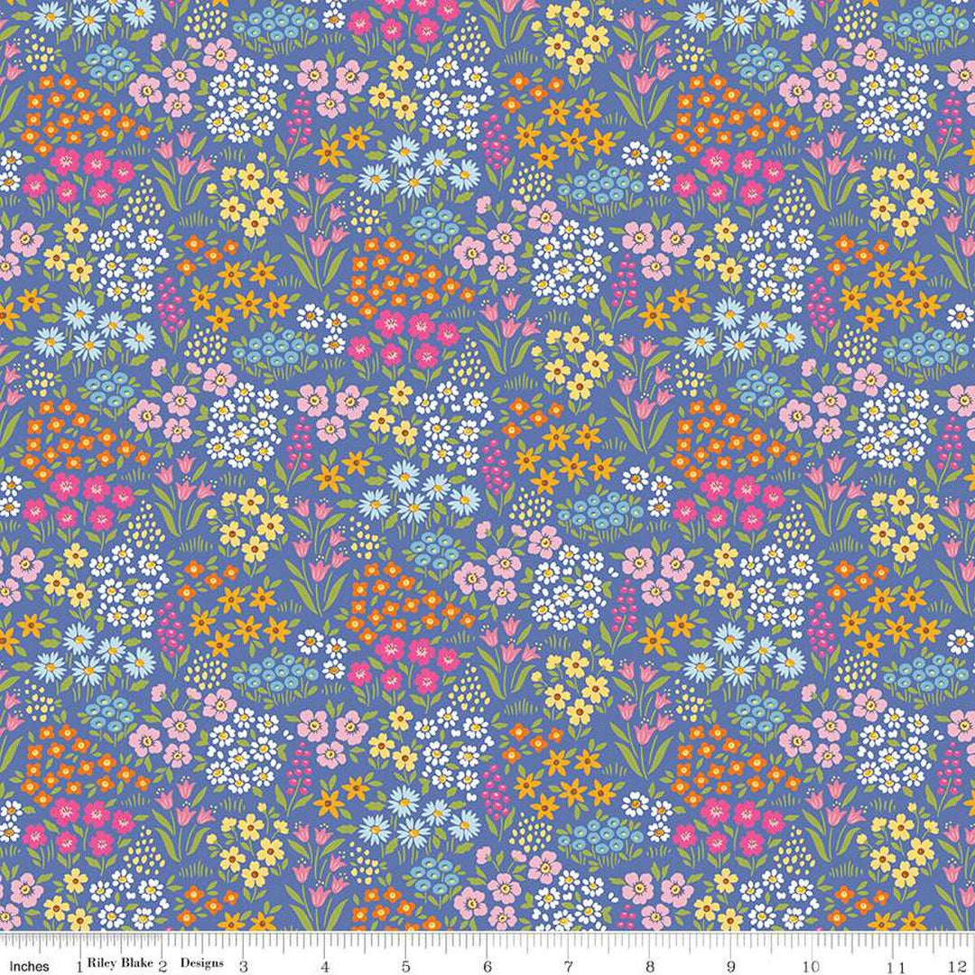 fabric swatch of various small groups of flowers in whites and pinks and yellows on a periwinkle background