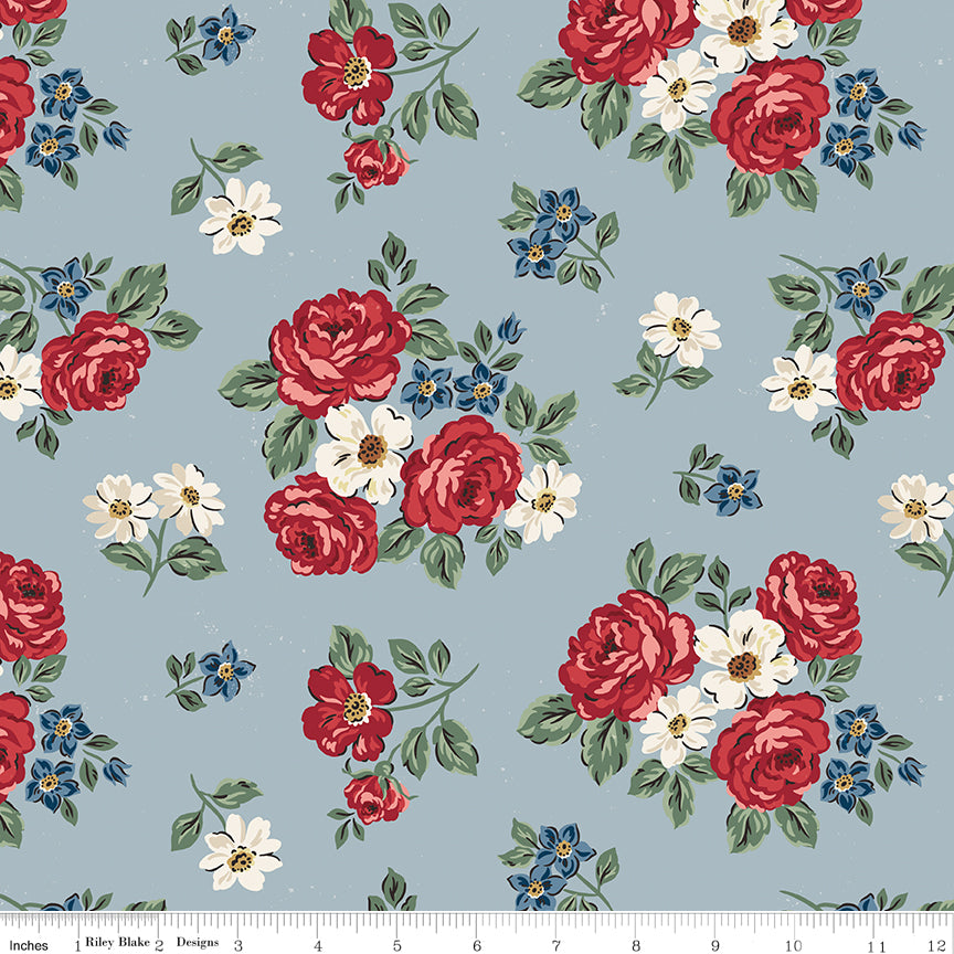 Floral pattern with red, white, and blue flowers on a light blue background.