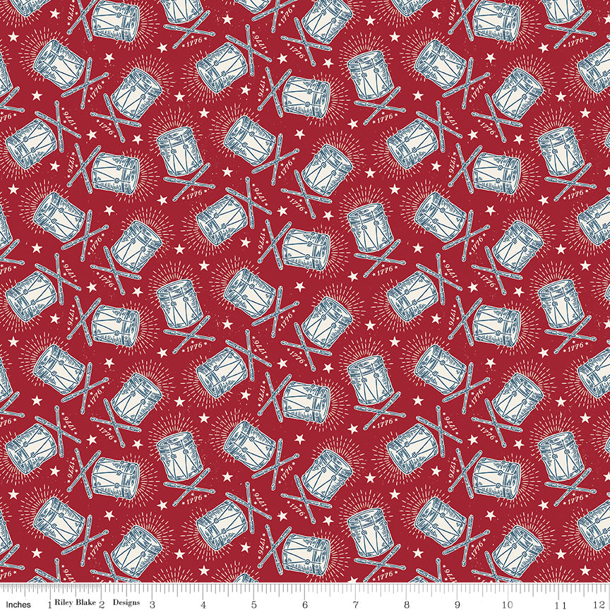 Pattern of drums and drumsticks on a red background with a fabric yardage label at the bottom.