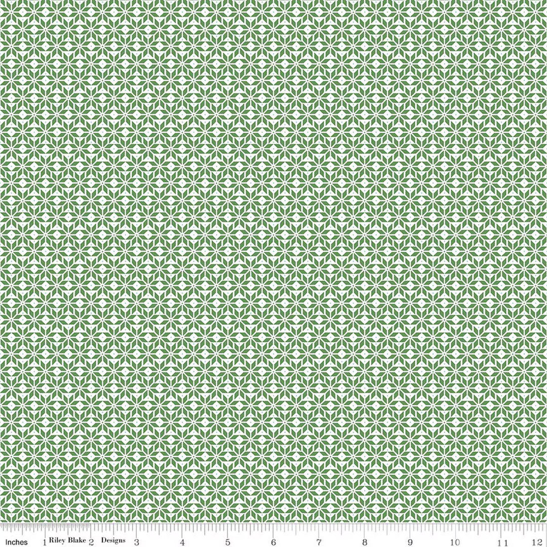 Green and white patterned fabric with a ruler at the bottom
