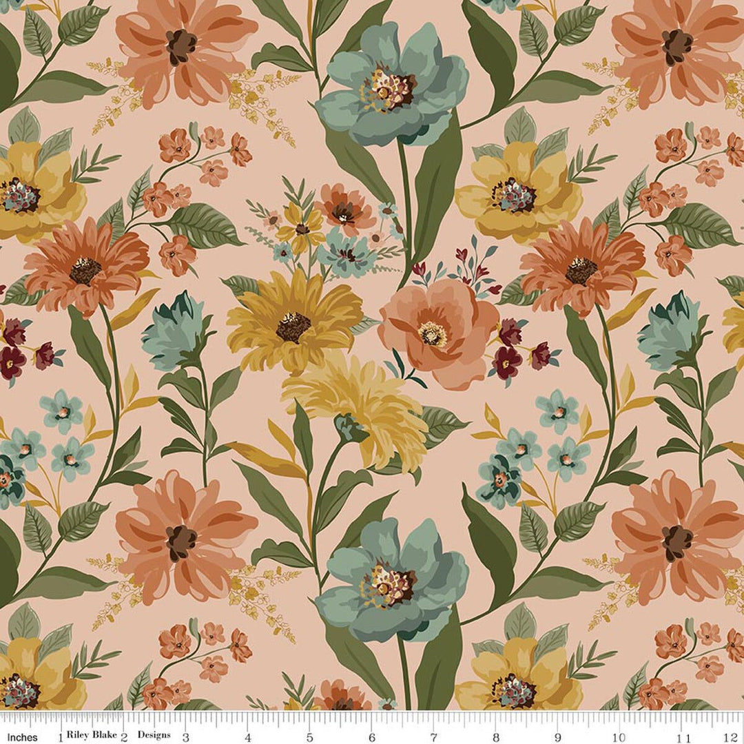 A repeating floral pattern on a warm peach background with large orange, yellow, and teal flowers, green leaves, and small blossoms. A white ruler strip appears along the bottom edge showing scale.