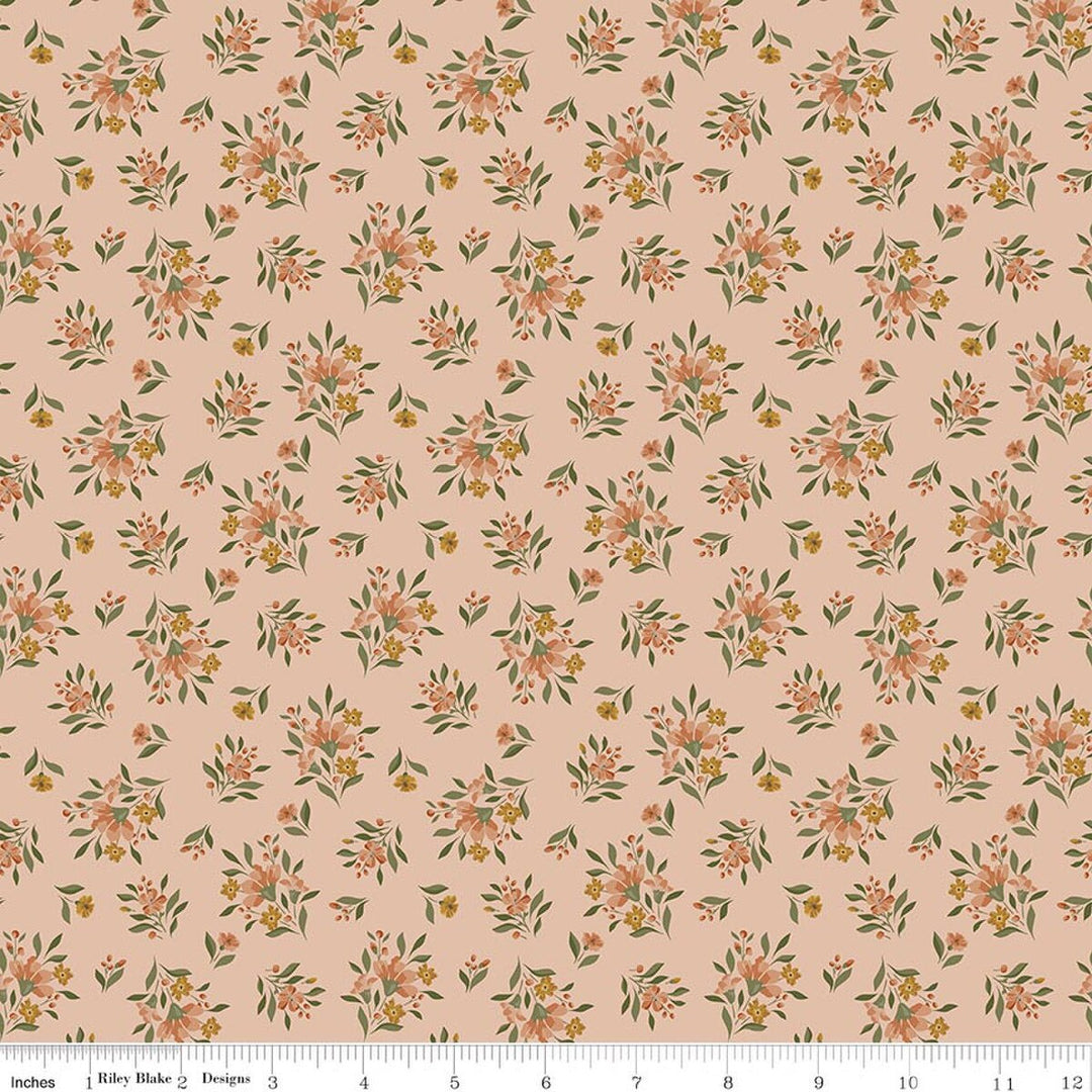 This print features small sprigs of orange and pink flowers and leaves on a warm peach background. A white ruler strip appears along the bottom edge showing scale.