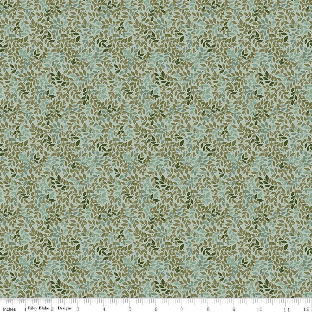 This print features small sprigs of green, and blue flowers and leaves on a cool teal background. A white ruler strip appears along the bottom edge showing scale.