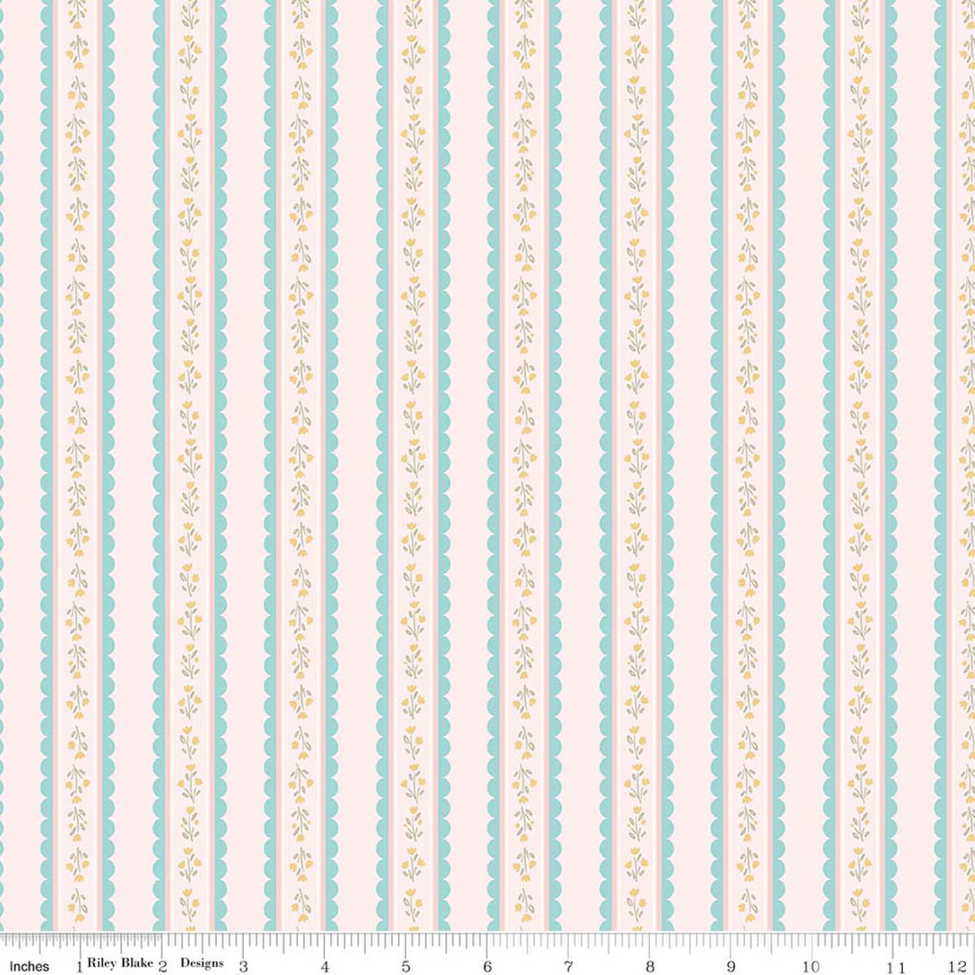 This print features scalloped stripes with sprigs of flowers on a light pink background. There is a ruler along the bottom for scale. 