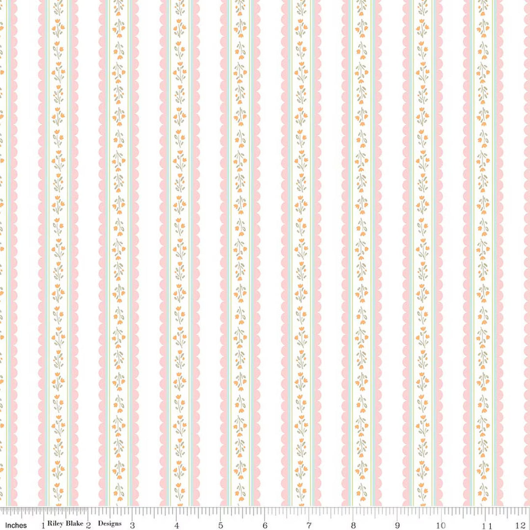This print features pink scalloped stripes with sprigs of flowers on a white background. There is a ruler along the bottom for scale. 