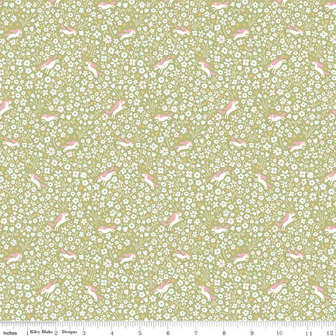 A repeating fabric pattern featuring pink rabbits and white flowers on a light olive green background, shown with a ruler along the bottom edge indicating scale.