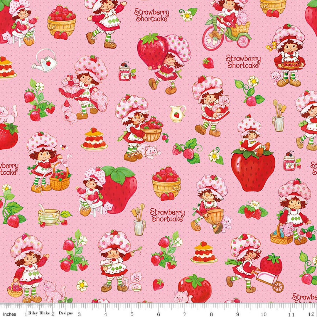 Pattern of Strawberry Shortcake characters and strawberries on a pink background with a ruler at the bottom.