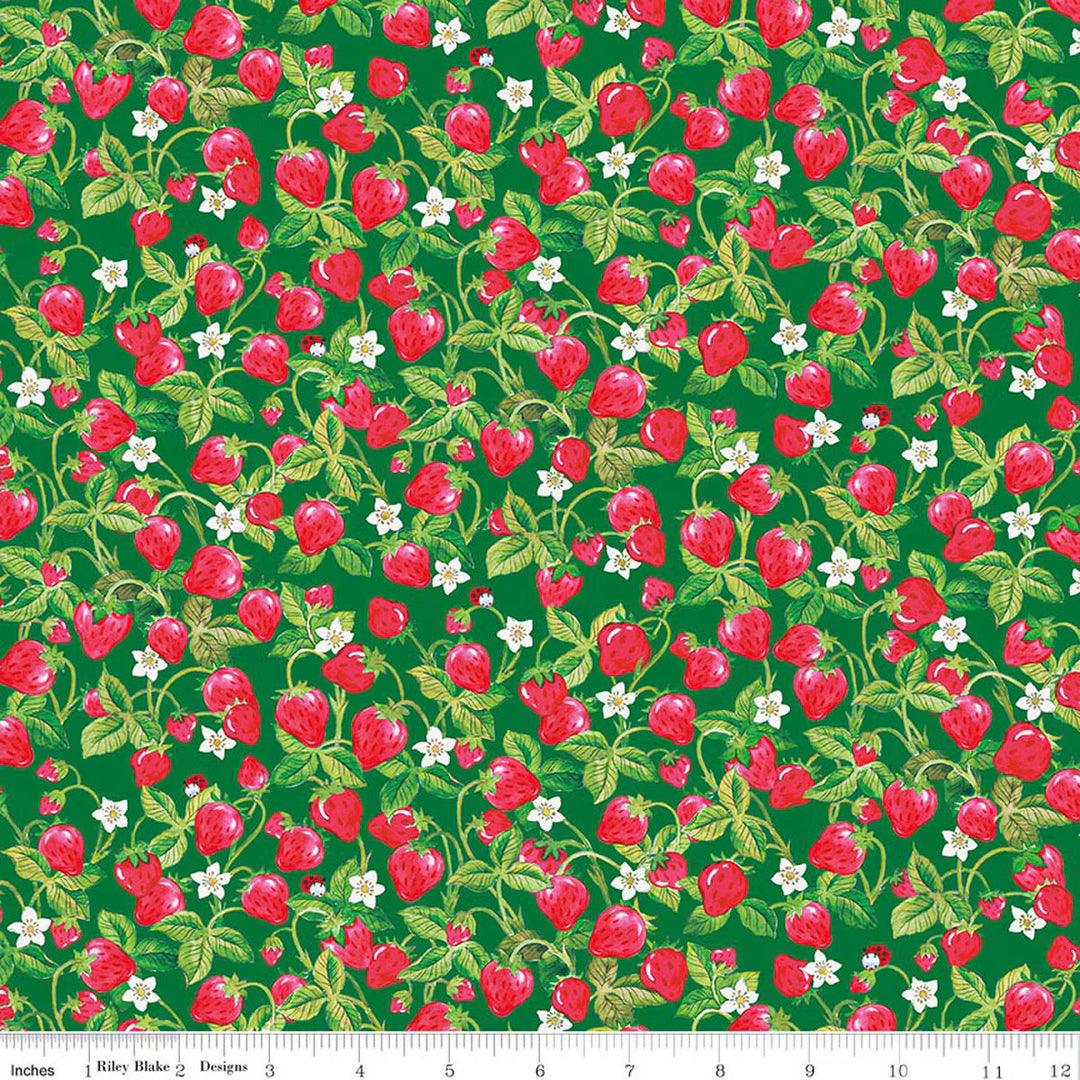 Pattern of red strawberries and green leaves on a green background with a fabric swatch at the bottom.