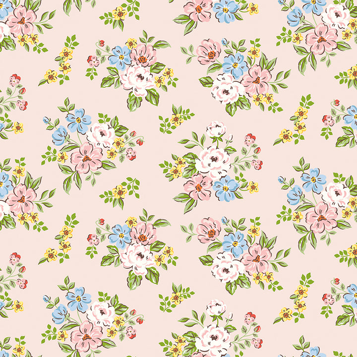 A repeating floral pattern on a pale blush pink background, featuring clusters of pink, white, and light blue flowers with green leaves and small yellow accents.