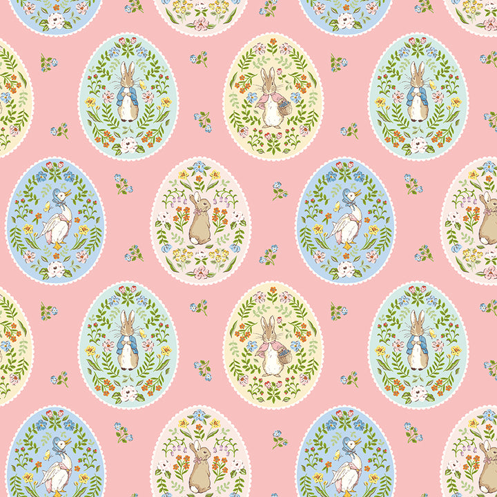 A repeating Easter-themed pattern featuring Peter Rabbit illustrations inside pastel blue and cream oval frames on a soft pink background, with small scattered floral motifs.