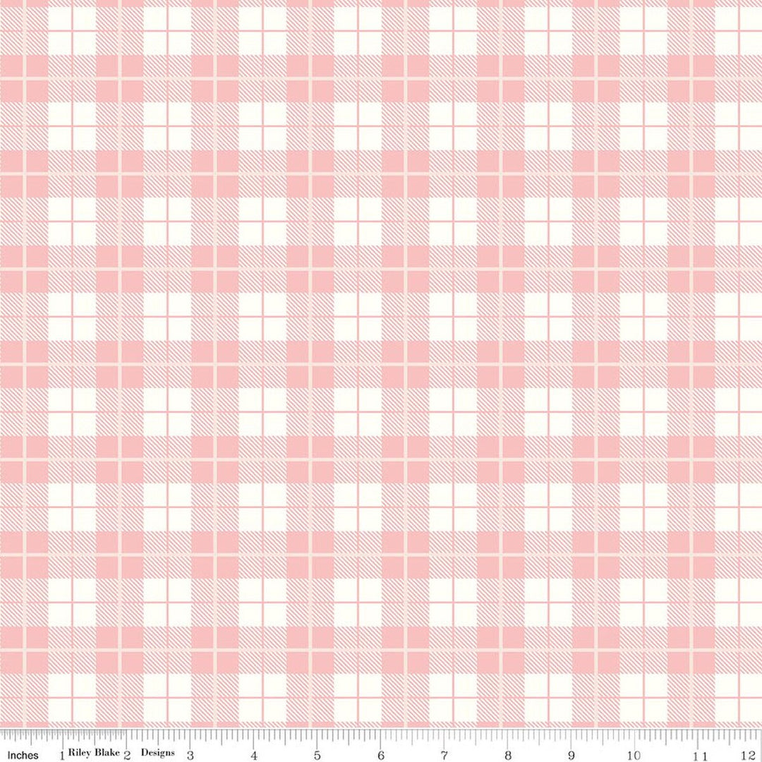 Pink and white plaid fabric pattern with a ruler at the bottom
