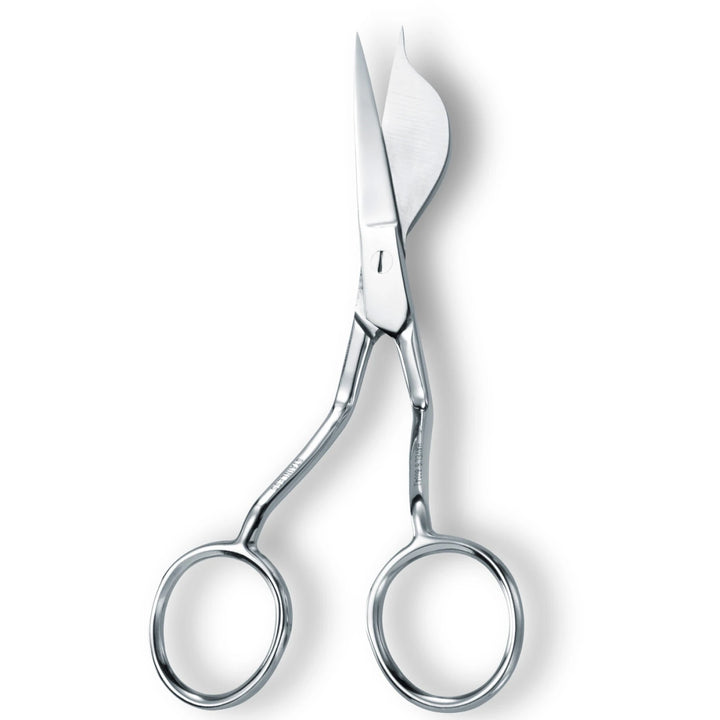 Pair of silver scissors on a white background